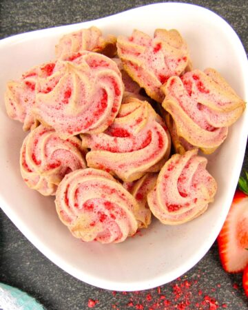 Strawberry Meringue Cookies in white bowl closeup overhead