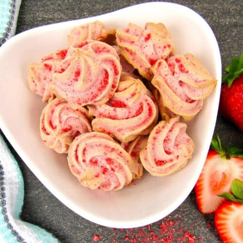 Strawberry Meringue Cookies in white bowl closeup overhead
