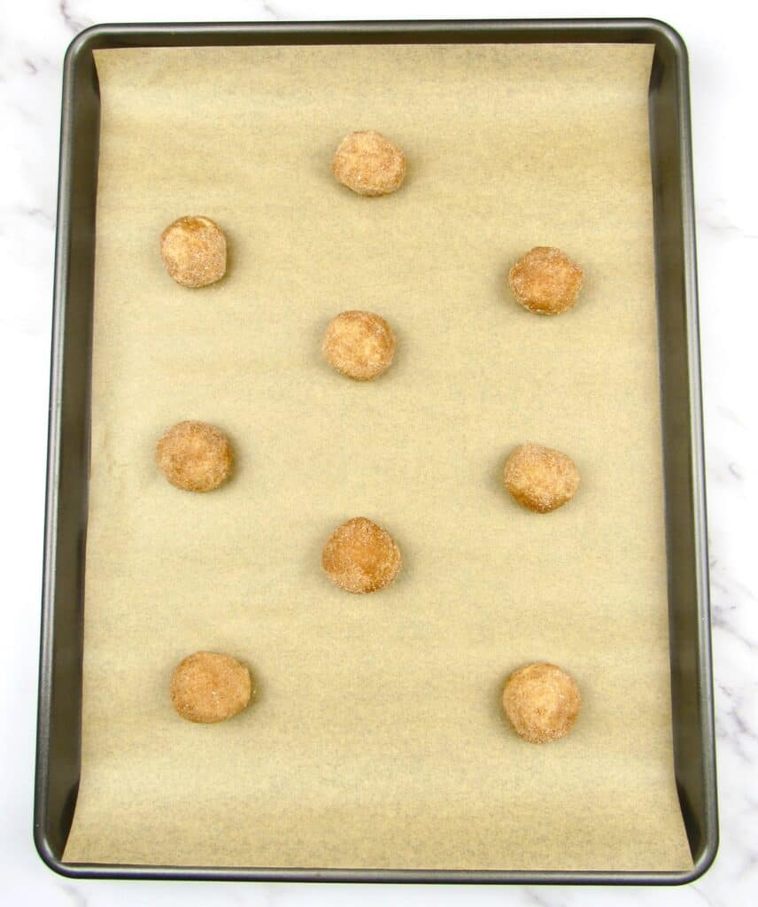 snickerdoodle dough balls on baking sheet