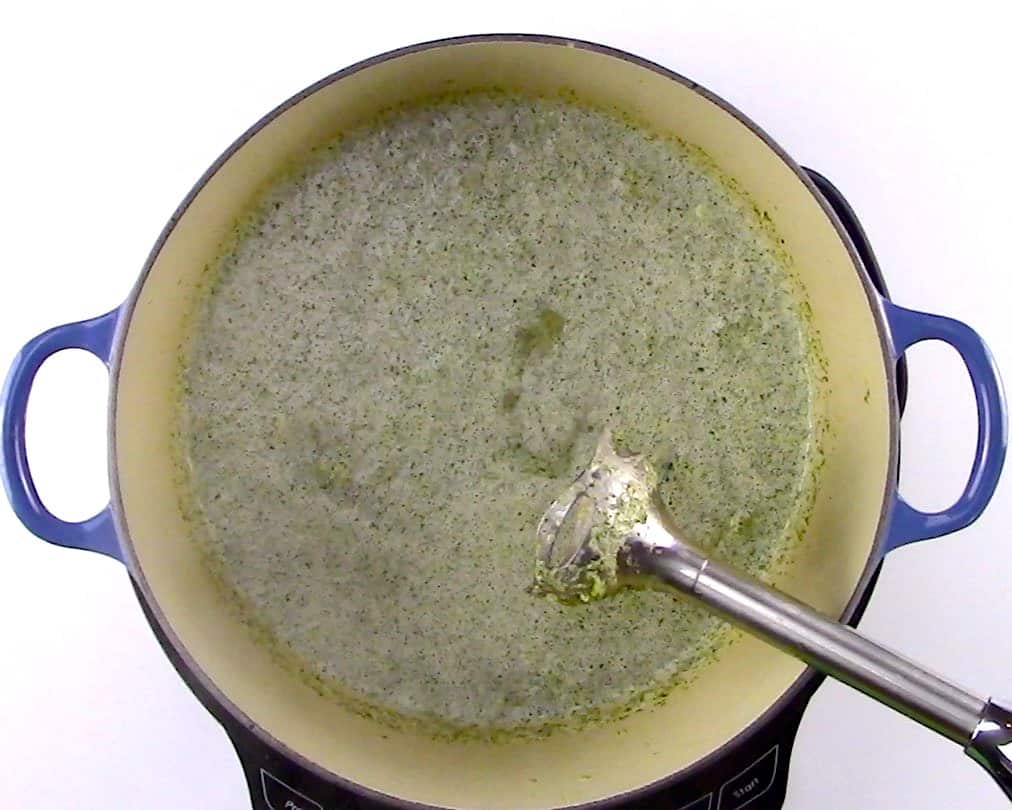 broccoli soup being pureed with immersion blender