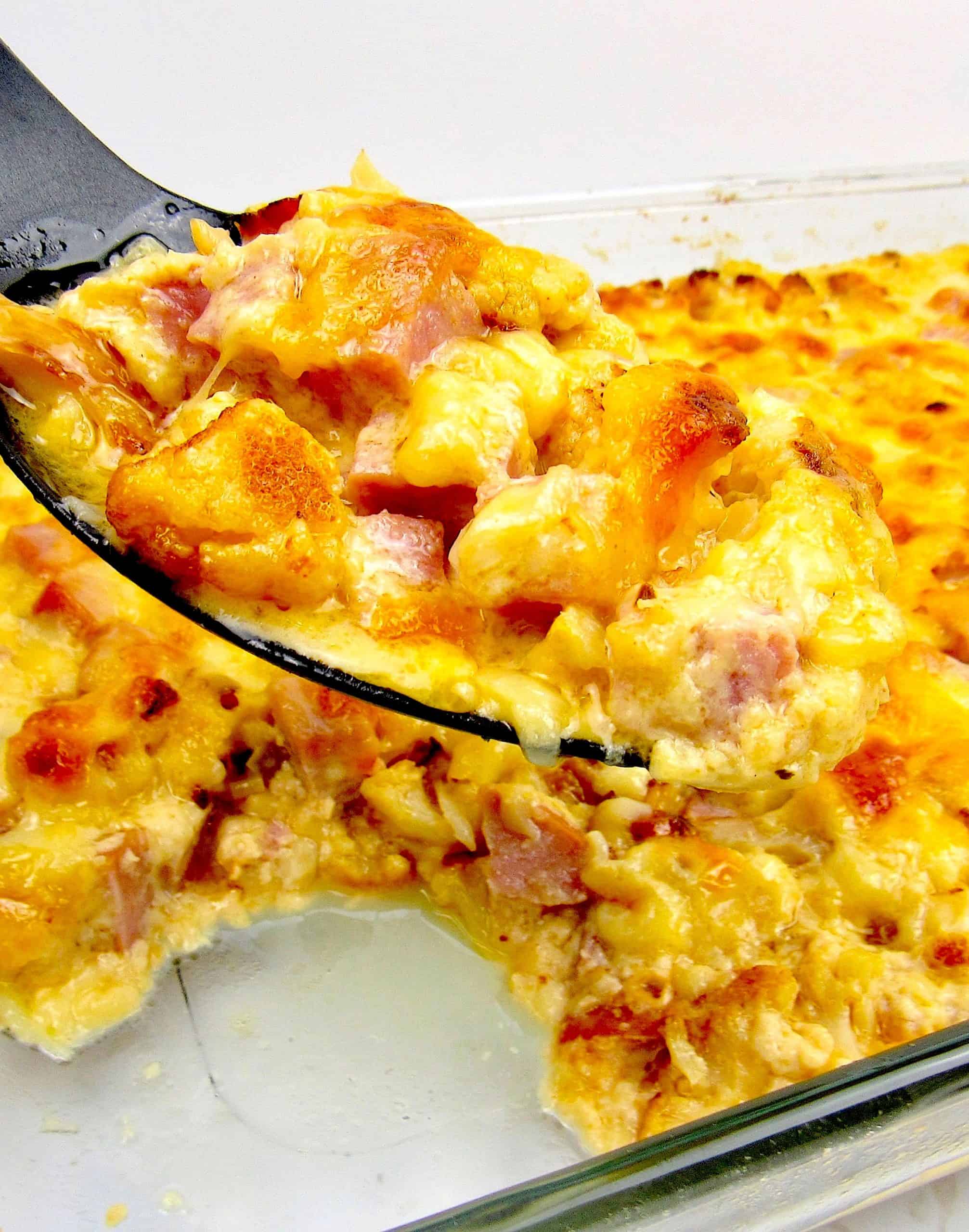 cauliflower and ham casserole with serving spoonful