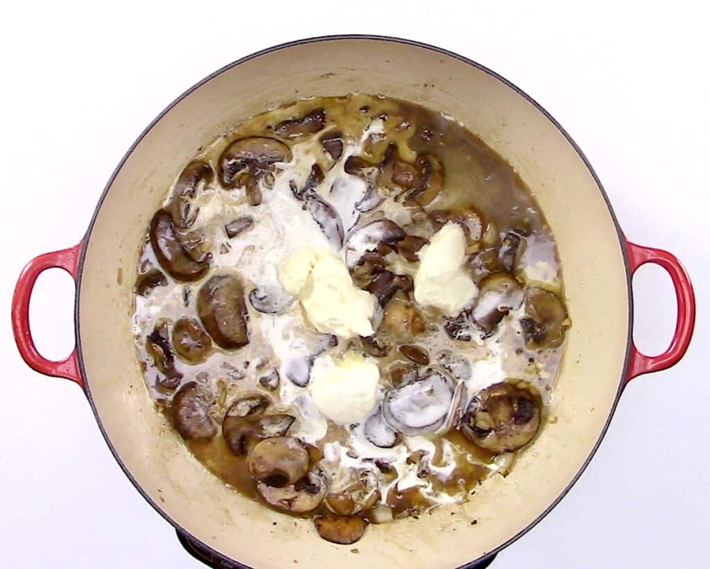 mushrooms and cheese in skillet cooking