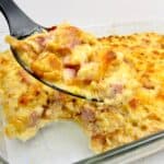 cauliflower and ham casserole with serving spoon ful
