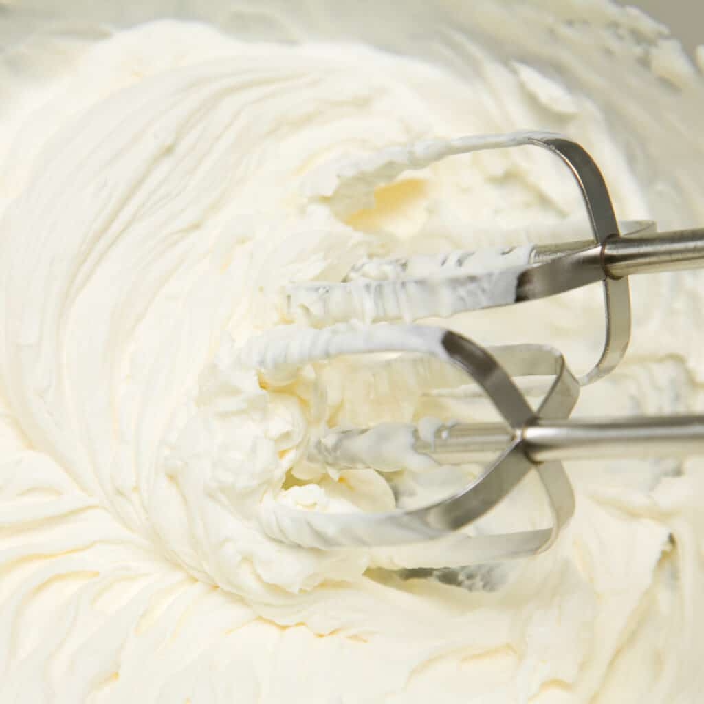 Heavy Cream whipped in bowl with beaters