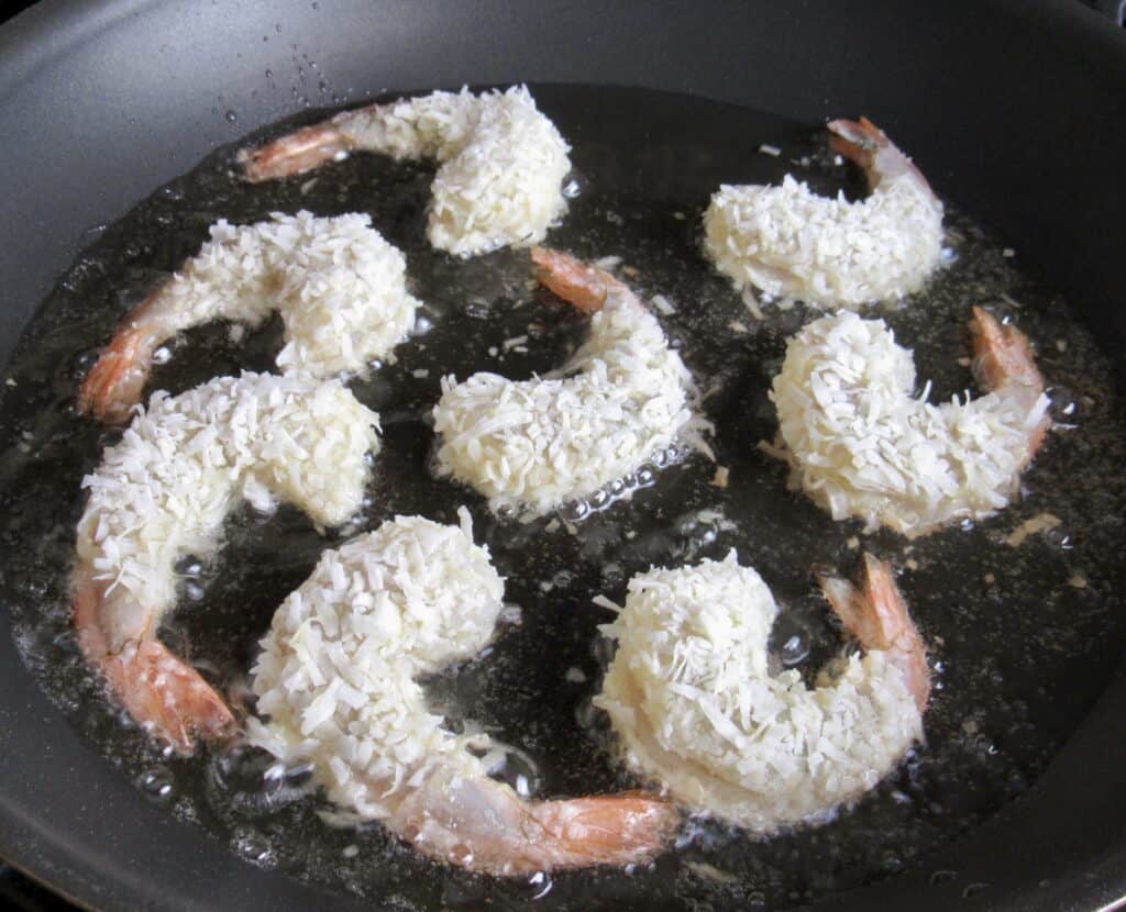 coconut shrimp frying in skillet