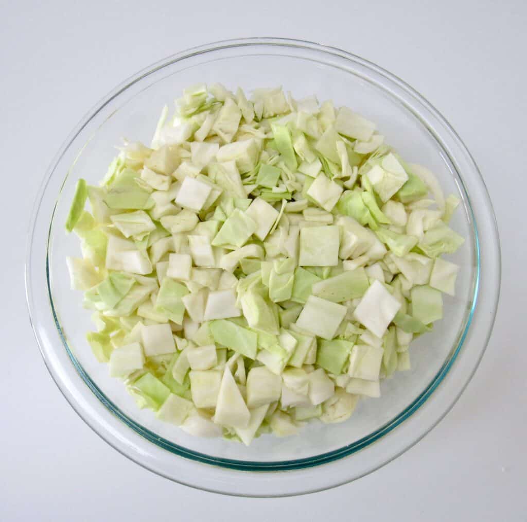 chopped green cabbage in glass bowl
