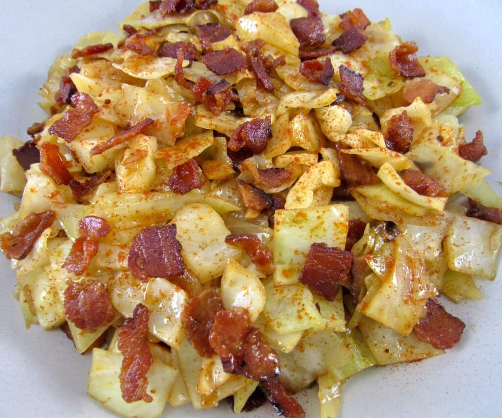 closeup of fried cabbage with bacon in bowl