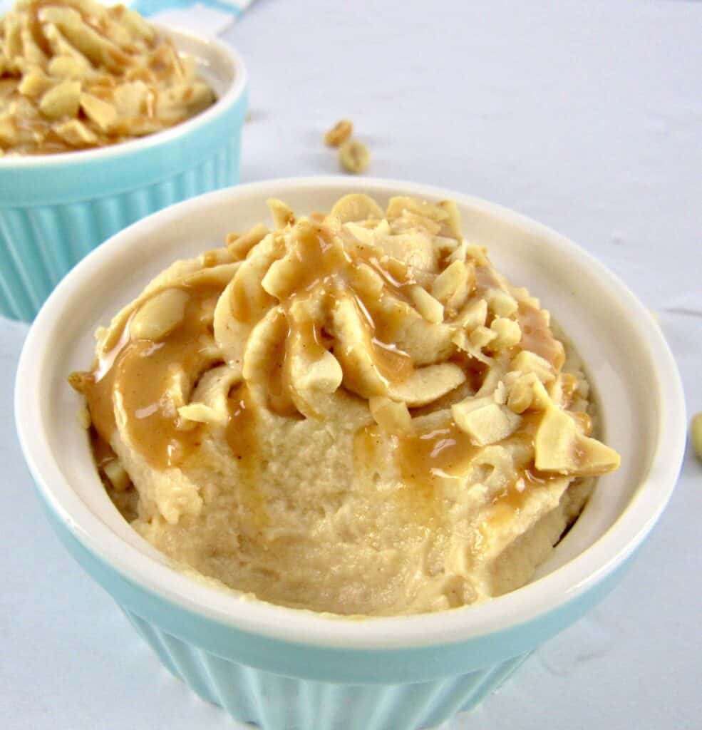 closeup of peanut butter mousse in turquoise ramekin with bite taken out