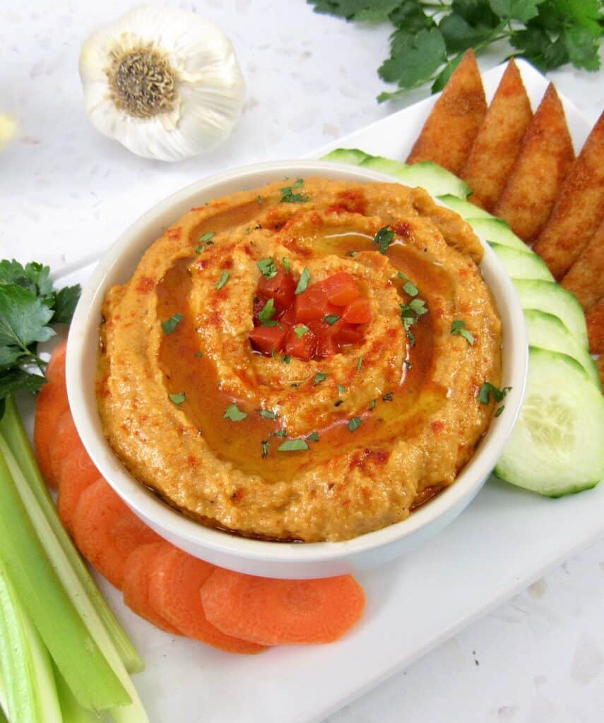 roasted red pepper cauliflower hummus on platter with veggies