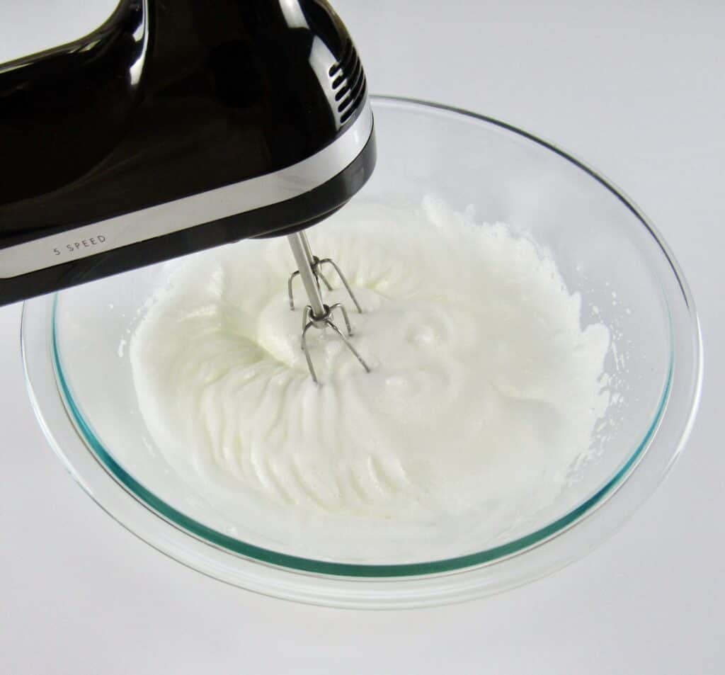 egg whites being whipped with hand mixer
