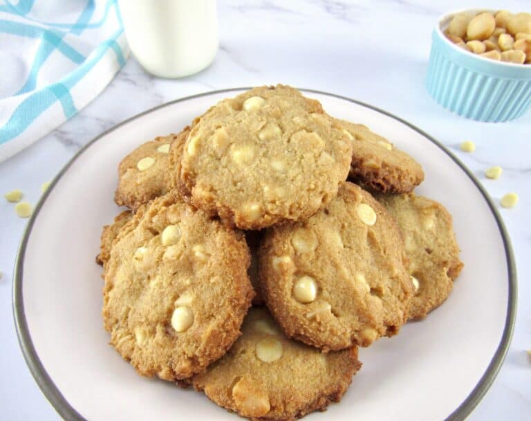 pile of white chocolate macadamia nut cookies on white plate