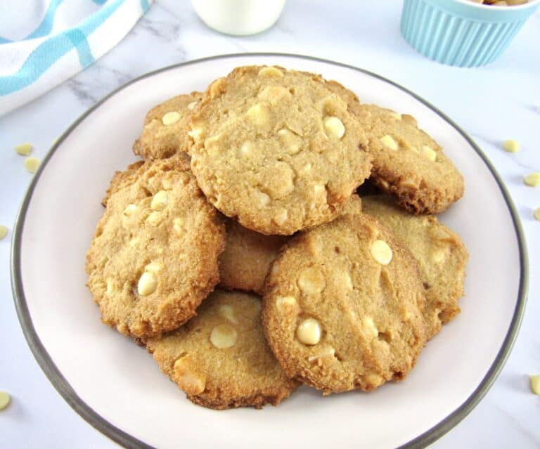 pile of white chocolate macadamia nut cookies on plate