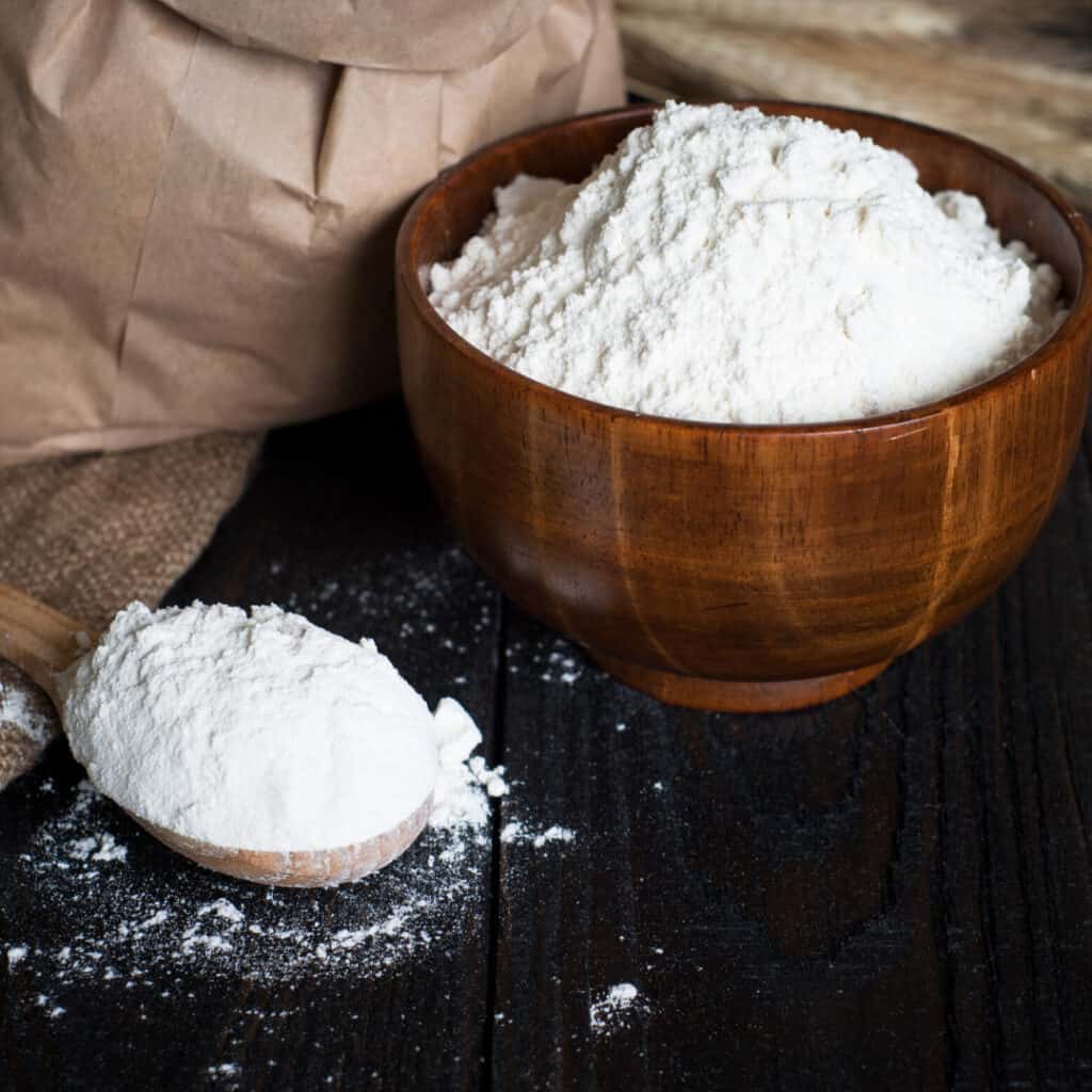 Oat Fiber in wooden bowl and wooden spoonful