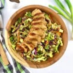 silced grilled chicken over cabbage salad