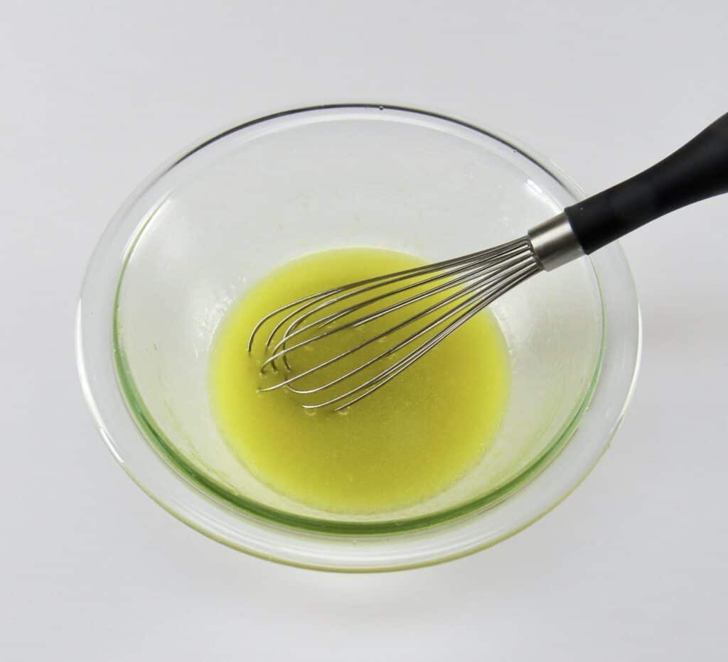lemon marinade in bowl with whisk