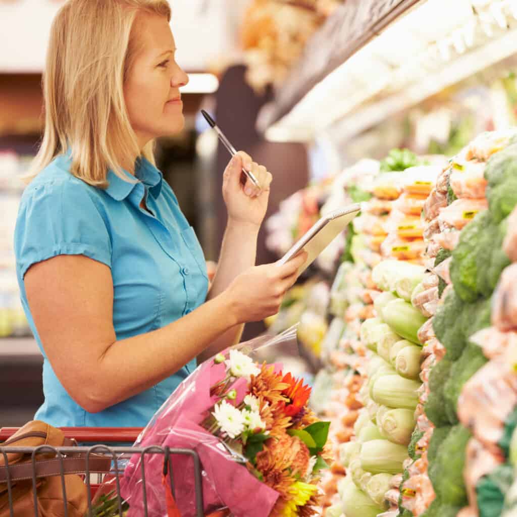 woman shopping with a grocery list