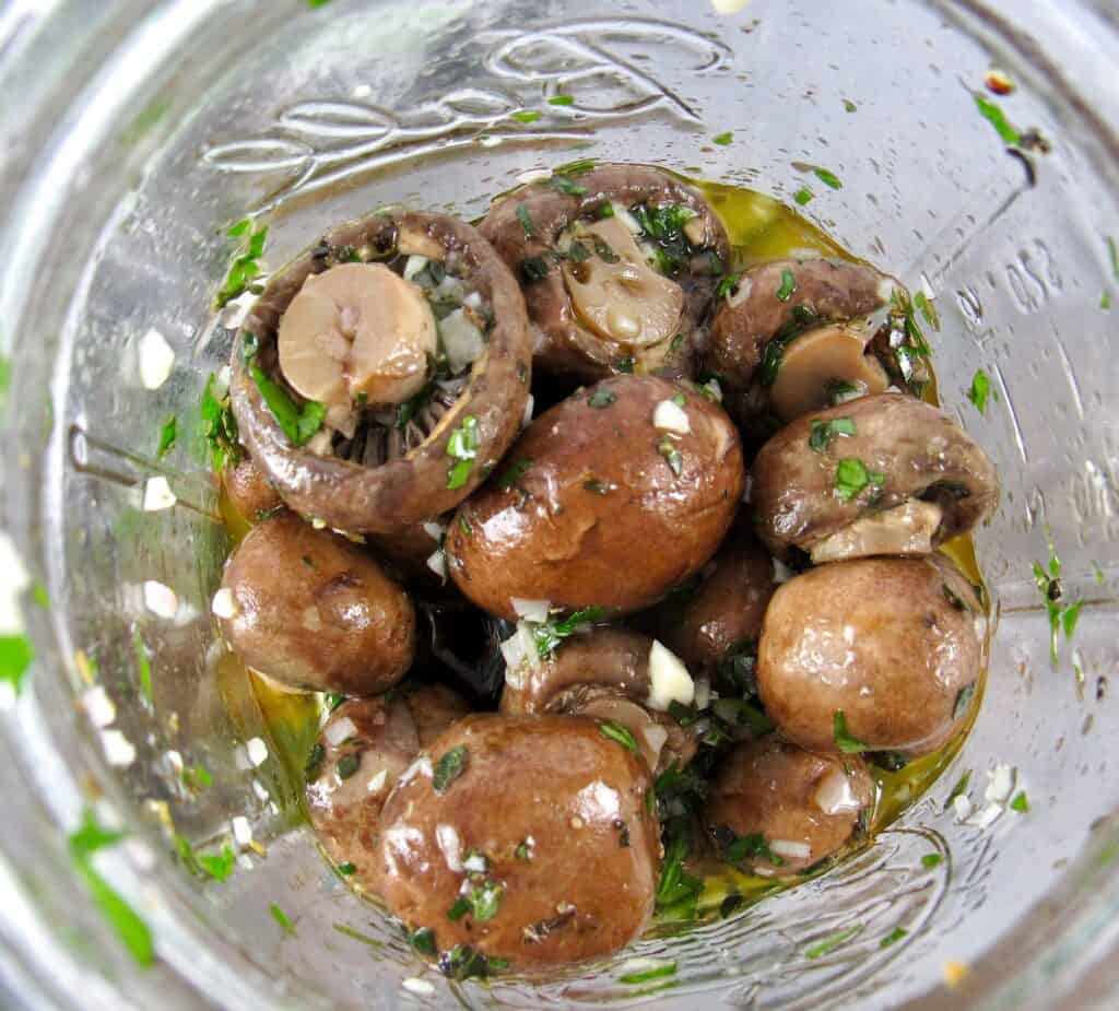 overhead view of marinated mushrooms in jar