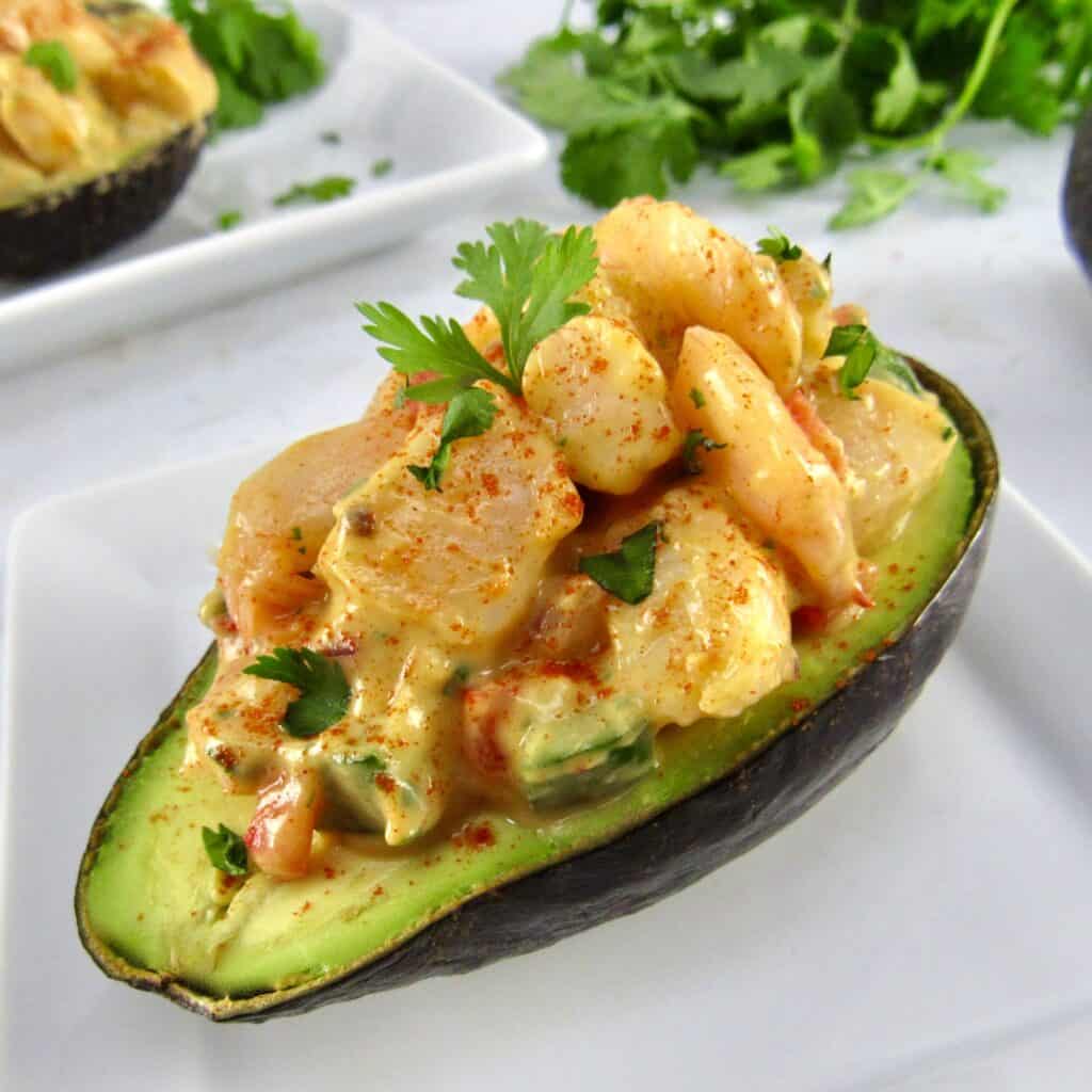 shrimp salad in ½ avocado with cilantro in background