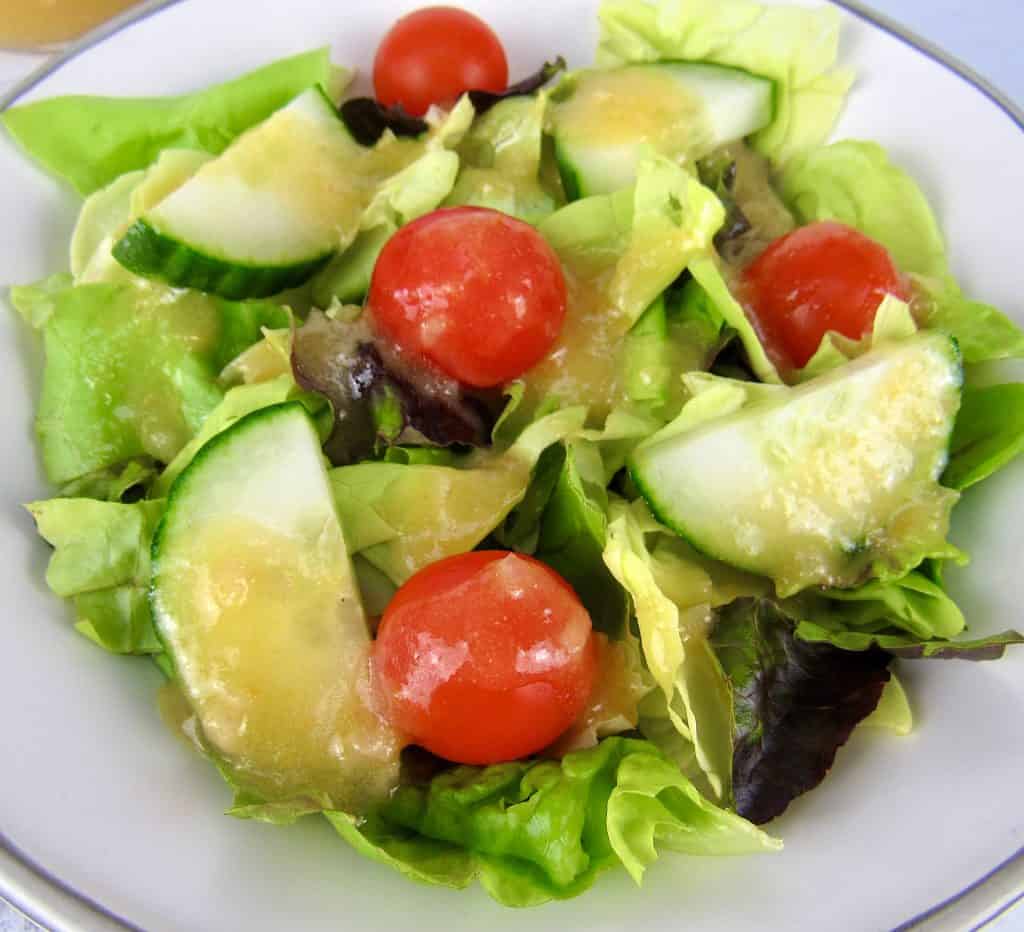 closeup of salad with apricot dressing on top