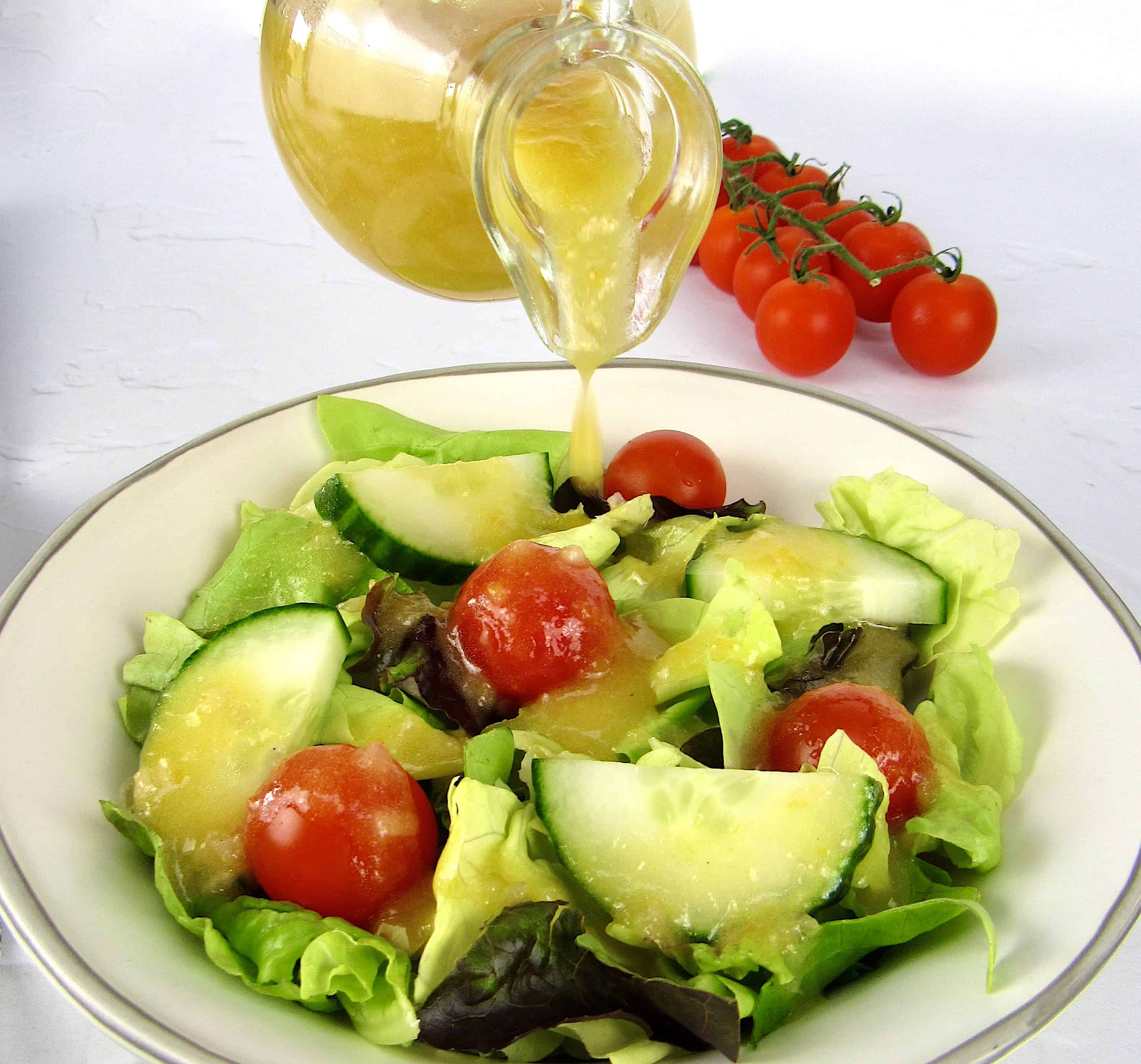 salad with apricot dressing being poured on top