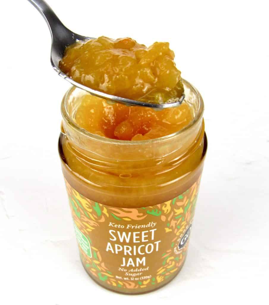 jar of Good Good apricot jam with some being spooned out