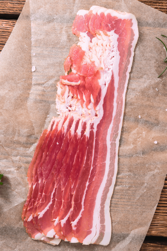 raw bacon on cutting board