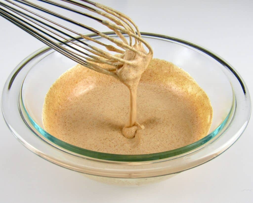 Zesty Dipping Sauce in glass bowl with whisk dripping