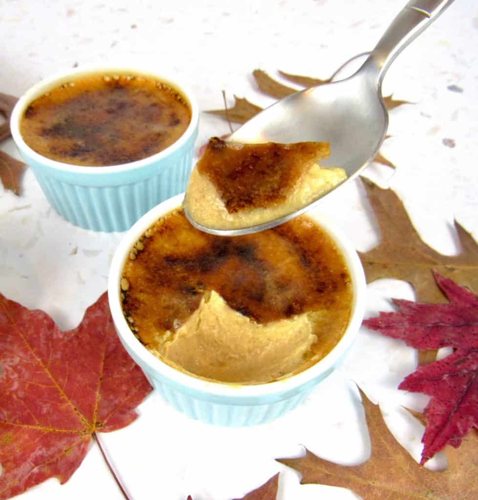pumpkin creme Brûlée in a ramekin with spoonful held up