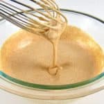 Zesty Dipping Sauce in glass bowl with whisk dripping