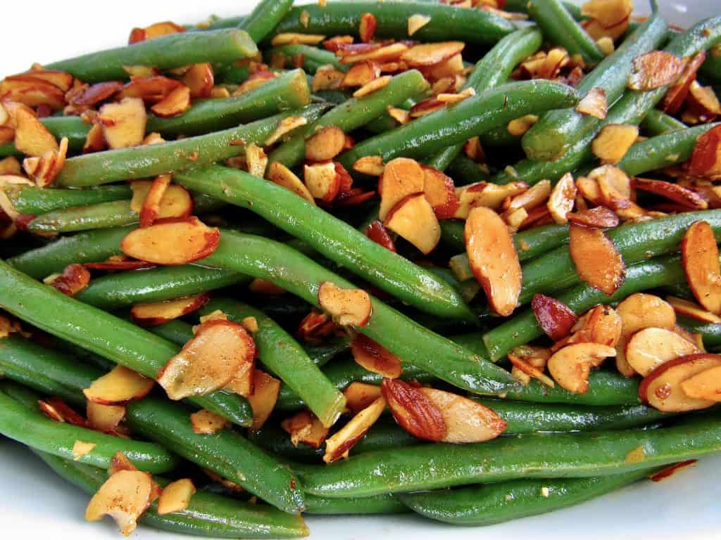 close up of green beans with almonds