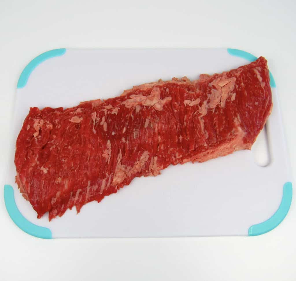 raw skirt steak on cutting board