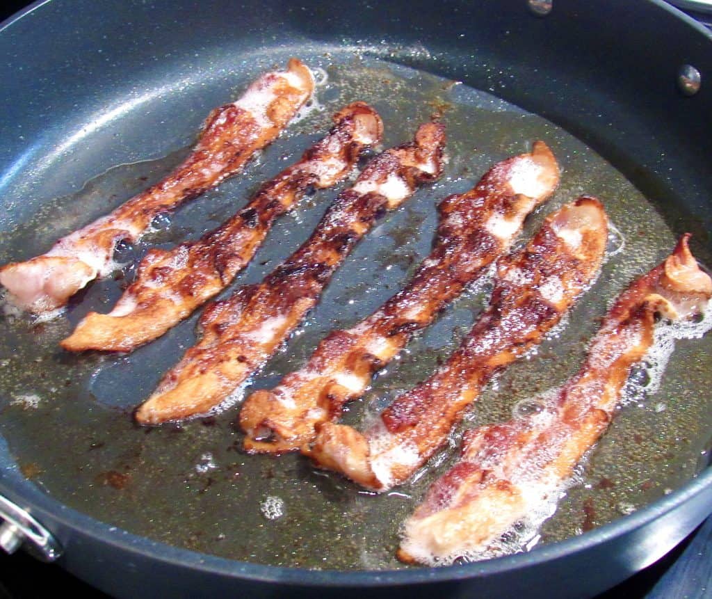 6 slices of bacon frying