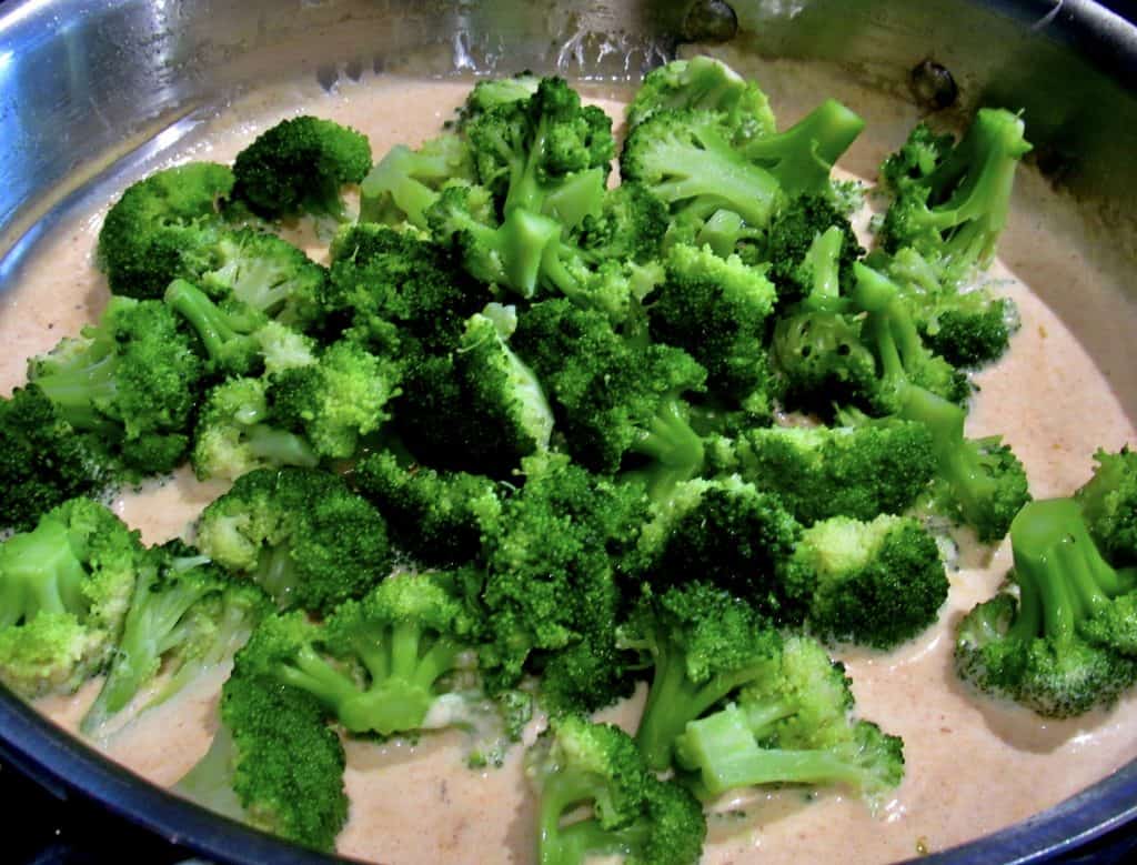 fresh broccoli in skillet with sauce
