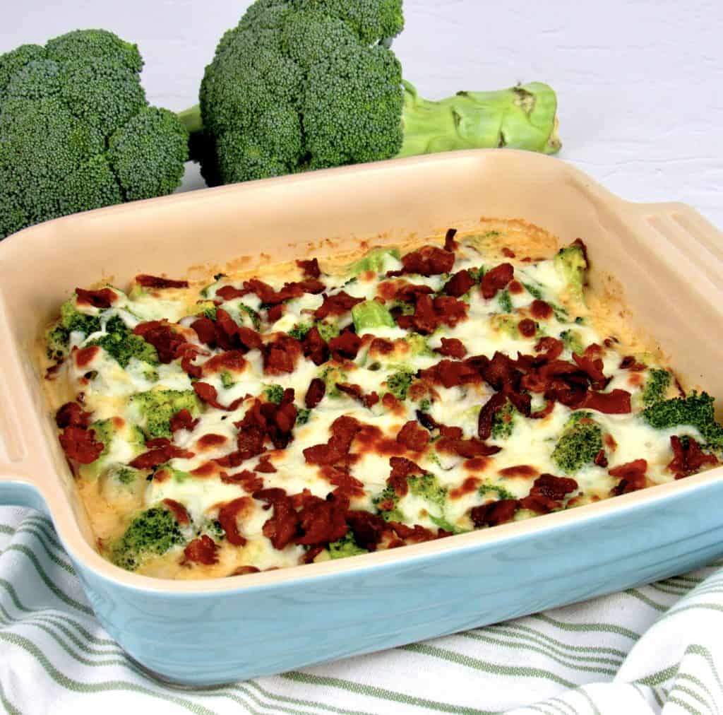 Broccoli Bacon Alfredo baked with raw broccoli in background