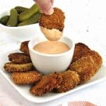 fried pickles being dipped in dipping sauce