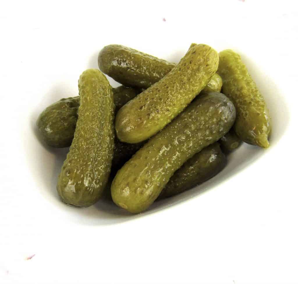 dill pickles in white bowl