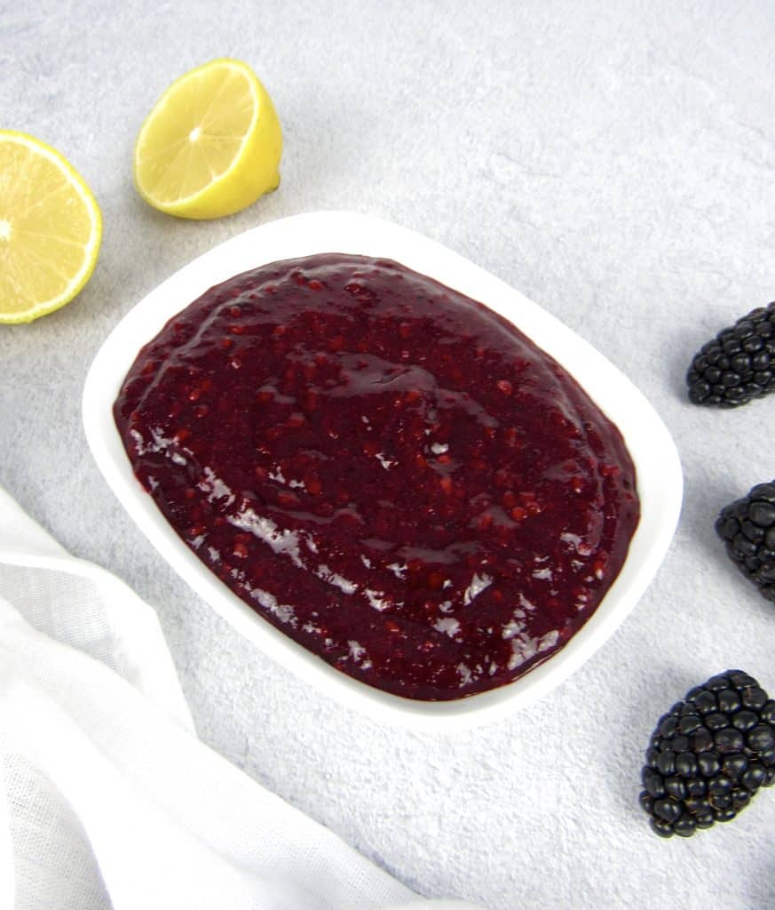overhead view of blackberry jam in white bowl