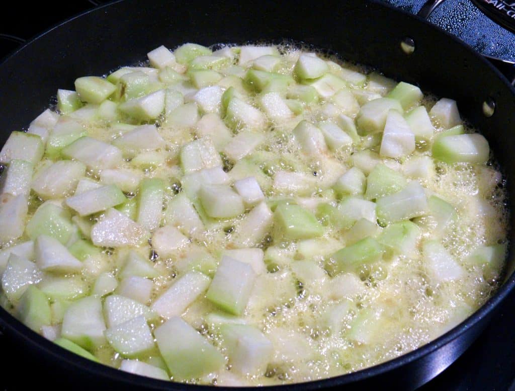 chayote squash cooking in skillet with butter
