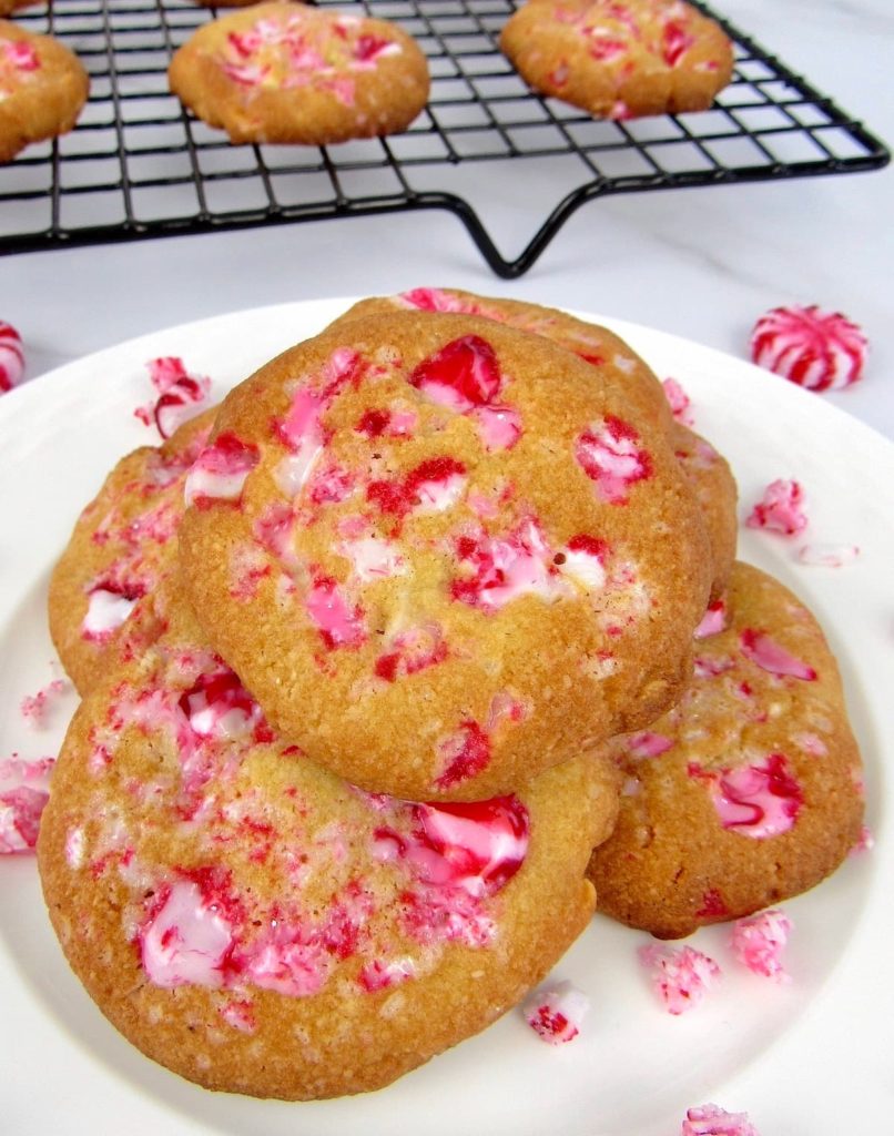 Keto White Chocolate Peppermint Cookies on white plate with cooling rack in back