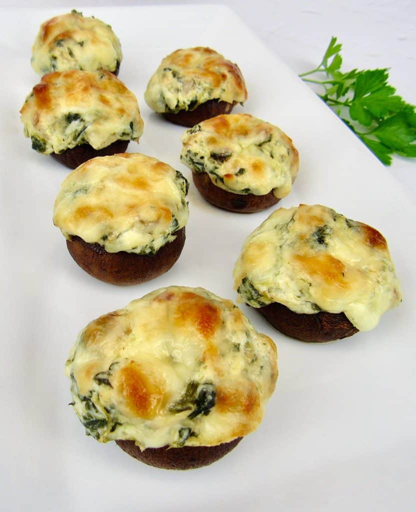 overhead view of Spinach Artichoke Stuffed Mushrooms on white plate