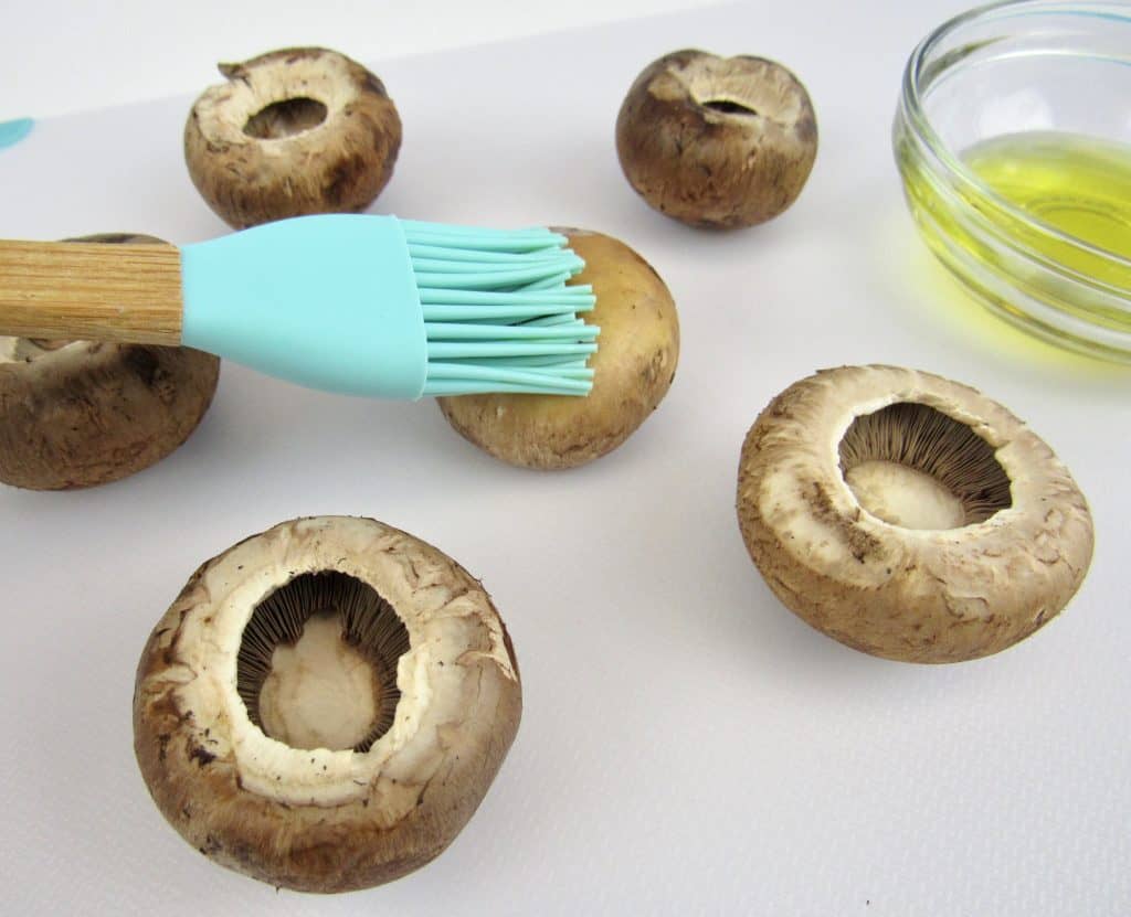 brushing mushroom caps with olive oil