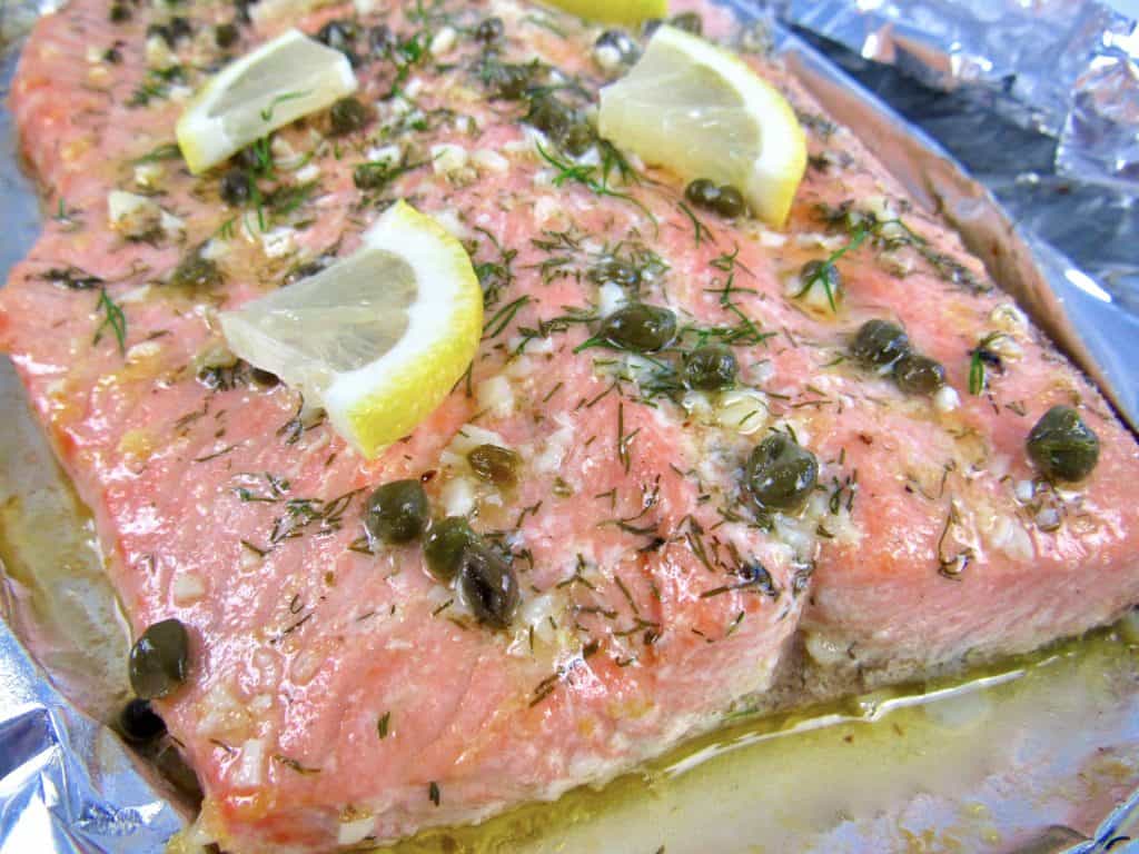 closeup of Baked Salmon in Foil with herbs on top