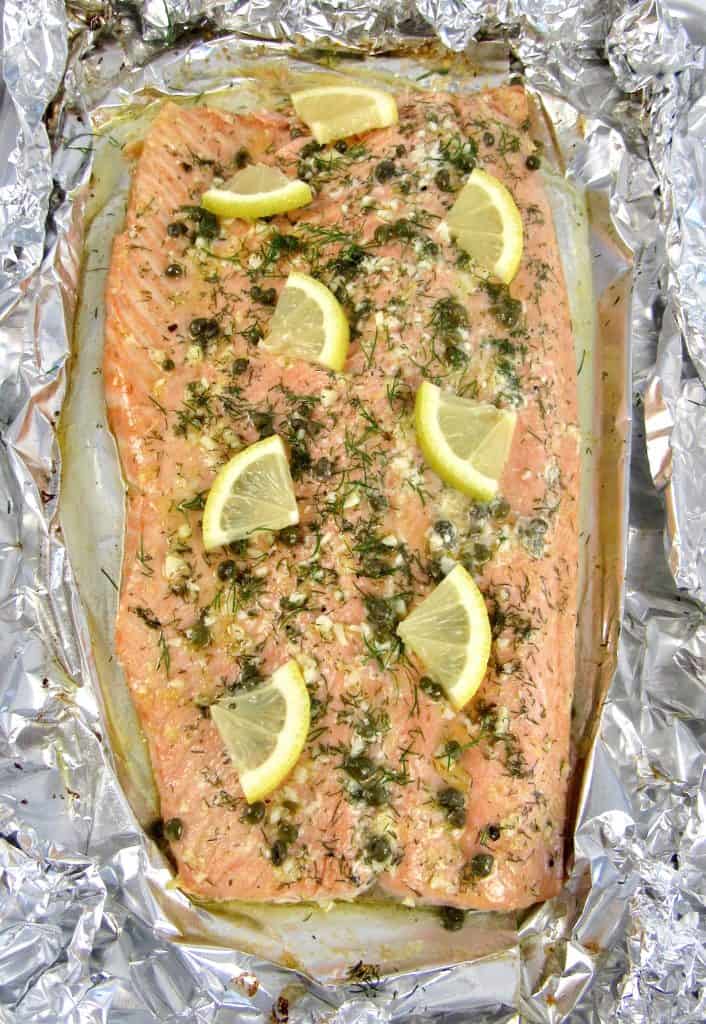 Baked Salmon in Foil with herbs and slices of lemon on top