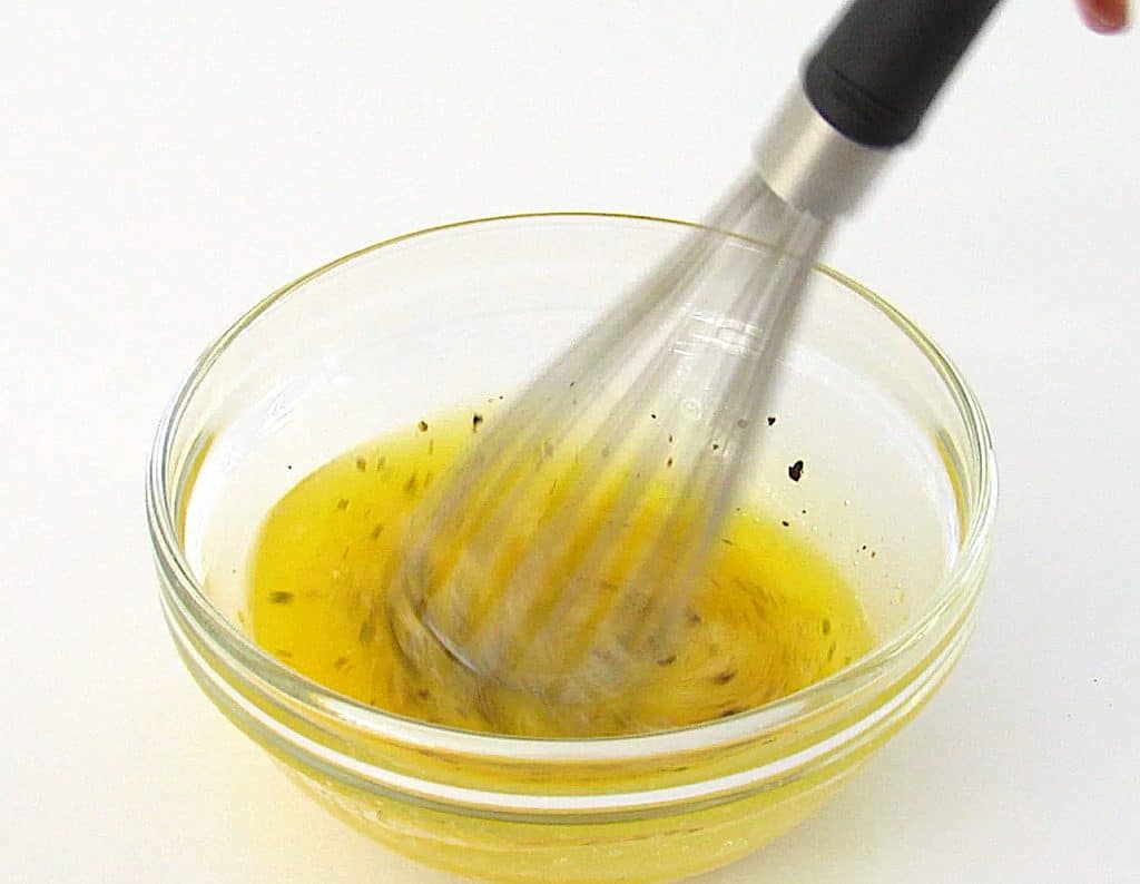 melted butter and spices in glass bowl with whisk