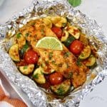 overhead closeup of salmon and veggies in foil baked