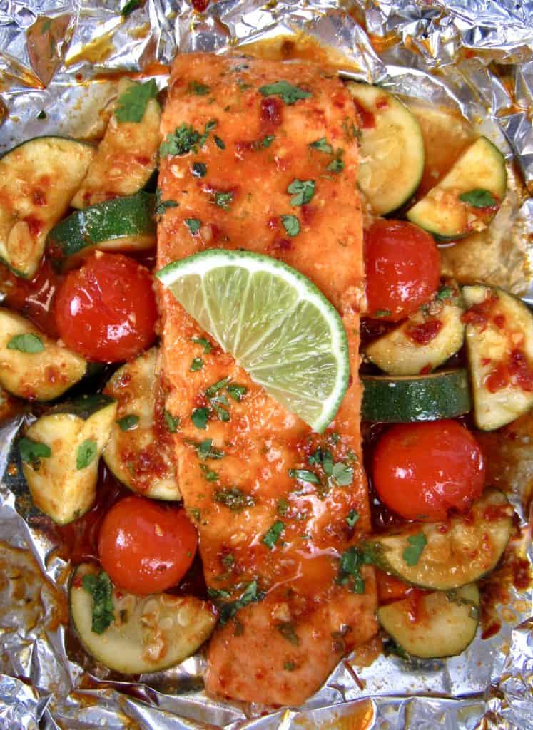 closeup of salmon and veggies in foil baked
