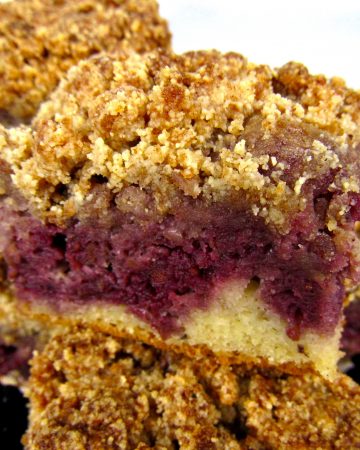 closeup of slices of blackberry coffee cake stacked on plate