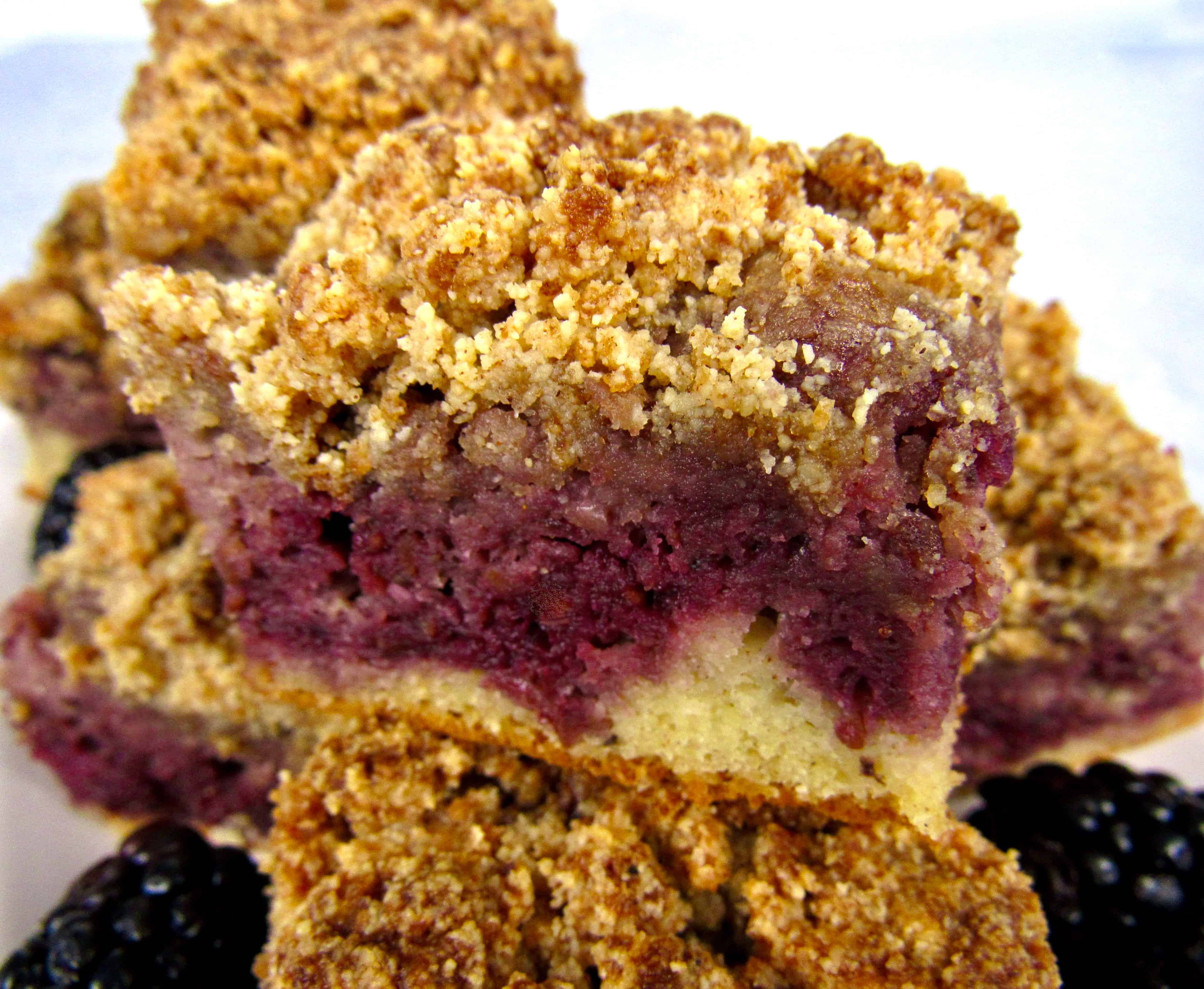 closeup of slices of blackberry coffee cake stacked on plate
