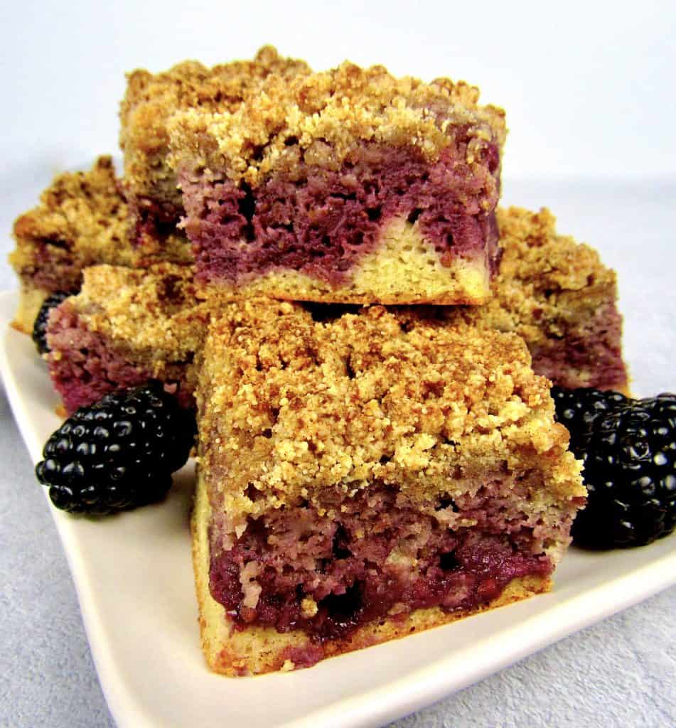 closeup of pieces of blackberry coffee cake stacked on plate