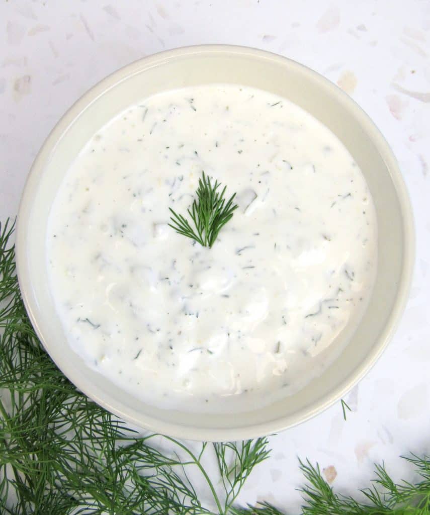 tartar sauce in bowl with dill on top and on the side